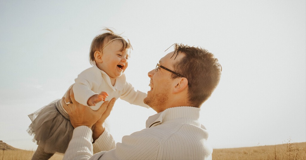 Baby laughing with dad while playing