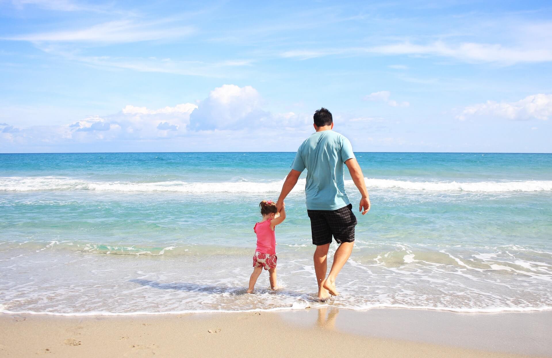 father and daughter on beach